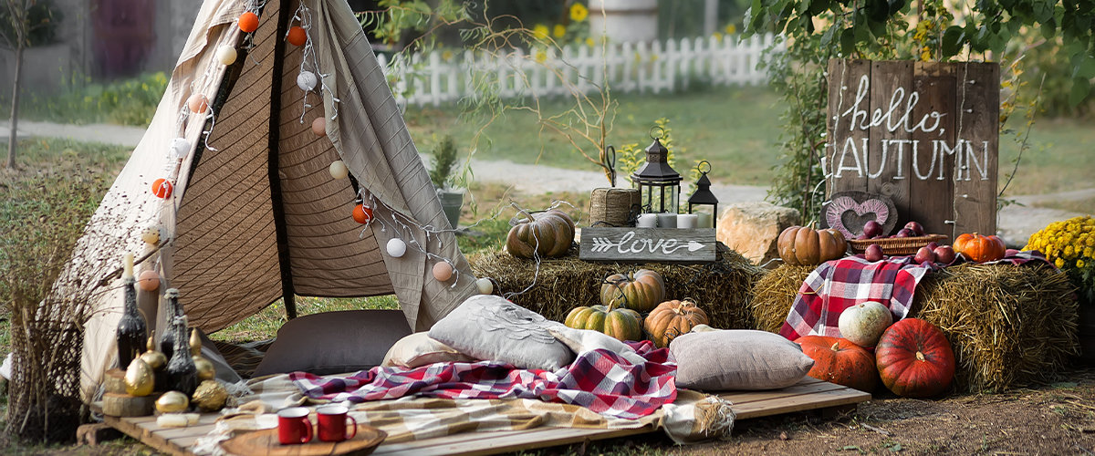 Fall themed backyard tent with hand painted signs